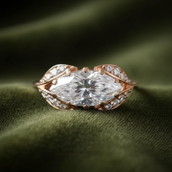 East-west marquise ring on dark olive green velvet