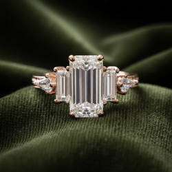 Emerald-cut ring on dark olive green velvet