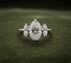 Engagement ring on dark olive green velvet