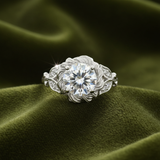 Engagement ring with floral side details on dark olive green velvet