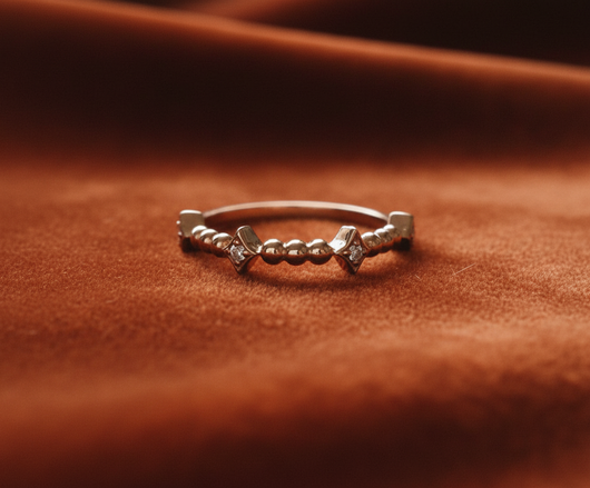 Rose gold geometric band on rust orange velvet