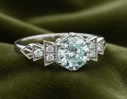 The Florence ring in white gold with soft aqua blue diamond on dark olive velvet