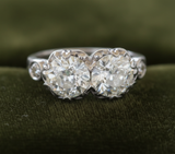 Two-stone diamond ring on dark olive green velvet